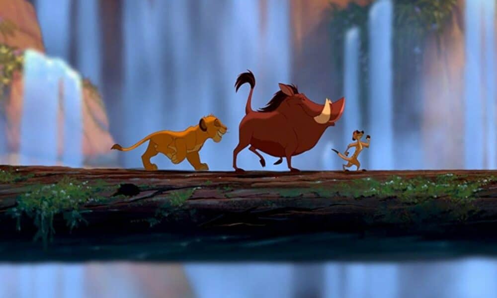 Simba, Timon, and Pumba walking on a fallen tree singing 'Hakuna Matata'.